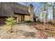 Exterior view with stone chimney and pathway to the front door surrounded by decorative stones and landscaping at 671 State Road 267, Mooresville, IN 46158