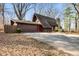 Charming A-frame home with brown siding, two car garage, stone chimney, and eye-catching red front door at 671 State Road 267, Mooresville, IN 46158