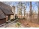 Beautiful exterior with stone chimney, gravel walkway, view of the lake, and path leading to the front door at 671 State Road 267, Mooresville, IN 46158