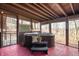 Hot tub on a screened-in porch with a red painted floor and views of the trees at 671 State Road 267, Mooresville, IN 46158