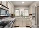 Bright kitchen features stainless steel appliances, ample counter space, and a window for natural light at 671 State Road 267, Mooresville, IN 46158