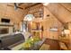 Open concept living area with hardwood floors, stone fireplace, and spiral staircase to lofted bonus area at 671 State Road 267, Mooresville, IN 46158