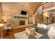 Spacious living room with stone fireplace, hardwood floors, loft, and spiral staircase to lofted bonus area at 671 State Road 267, Mooresville, IN 46158