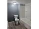 Bright bathroom featuring a new toilet, and a bathtub with a white shower surround at 724 E Beecher St, Indianapolis, IN 46203