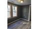 Bedroom features new flooring, two large windows providing natural light, and gray colored walls at 724 E Beecher St, Indianapolis, IN 46203