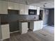 A kitchen featuring white cabinets and a microwave installed over the sink area at 724 E Beecher St, Indianapolis, IN 46203