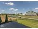 A backyard view from the patio showing a pond and green space on a bright day at 7367 Broadview Ln, McCordsville, IN 46055