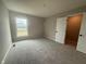 Comfortable bedroom with soft carpeting, ample natural light, and a closet for storage at 7367 Broadview Ln, McCordsville, IN 46055