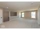 Large carpeted bonus room with two windows, a stairwell, and neutral-toned walls at 7367 Broadview Ln, McCordsville, IN 46055