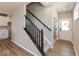Bright stairway and entryway with wood-look flooring, modern railing, and a view to the kitchen at 7367 Broadview Ln, McCordsville, IN 46055