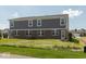 A shot of the back of this two-story home with a walkout basement and grassy yard at 7367 Broadview Ln, McCordsville, IN 46055