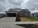 Newly constructed brick home with an attached two-car garage and freshly laid landscaping at 7367 Broadview Ln, McCordsville, IN 46055
