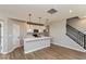 Bright, open kitchen with white cabinets, stainless steel appliances, a center island, and wood-look flooring at 7367 Broadview Ln, McCordsville, IN 46055
