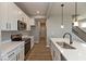 Modern kitchen features white cabinets, stainless steel appliances, and a center island with pendant lights at 7367 Broadview Ln, McCordsville, IN 46055