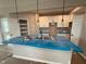 Modern kitchen featuring white cabinets, an island sink, and elegant pendant lighting at 7367 Broadview Ln, McCordsville, IN 46055