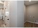 Neutral colored laundry room with a white door, wood-look flooring, and hookups for a washer and dryer at 7367 Broadview Ln, McCordsville, IN 46055
