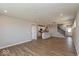 Spacious living area featuring hardwood floors and an open layout connected to kitchen and stairs at 7367 Broadview Ln, McCordsville, IN 46055