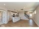 Inviting living area showcasing hardwood floors, an island kitchen, and staircase access at 7367 Broadview Ln, McCordsville, IN 46055