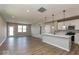 Open concept kitchen and living space with wood-look flooring, white kitchen, and lots of natural light at 7367 Broadview Ln, McCordsville, IN 46055