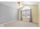 Bedroom featuring vaulted ceiling, window, ceiling fan and neutral carpet flooring at 7415 Chapel Villas Dr # D, Indianapolis, IN 46214