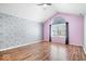 Spacious bedroom with vaulted ceiling, modern flamingo wallpaper and hardwood flooring throughout at 7415 Chapel Villas Dr # D, Indianapolis, IN 46214