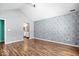 Spacious bedroom with vaulted ceiling, modern flamingo wallpaper and hardwood flooring throughout at 7415 Chapel Villas Dr # D, Indianapolis, IN 46214