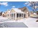 Charming home featuring neutral siding, stone accents, snow-covered lawn, and picturesque blue sky at 7415 Chapel Villas Dr # D, Indianapolis, IN 46214