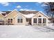 Charming home featuring neutral siding, stone accents, snow-covered lawn, and picturesque blue sky at 7415 Chapel Villas Dr # D, Indianapolis, IN 46214
