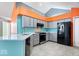 Modern kitchen with stainless steel appliances, tile flooring, and bright lighting at 7415 Chapel Villas Dr # D, Indianapolis, IN 46214