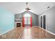 Bright living room features vaulted ceiling, fireplace, rich hardwood flooring, and natural light at 7415 Chapel Villas Dr # D, Indianapolis, IN 46214