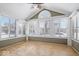 Bright sunroom with vaulted ceiling, multiple windows allowing ample natural light, and wood-look flooring at 7415 Chapel Villas Dr # D, Indianapolis, IN 46214