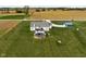 Aerial image showcases a home with a pool, storage shed, and green space at 8225 W 825 N, Thorntown, IN 46071