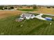 Aerial image shows a property with a pool, shed, spacious lawn, and fire pit at 8225 W 825 N, Thorntown, IN 46071