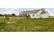 Large backyard features a wood deck with stairs, patio, and fire pit perfect for outdoor entertaining at 8225 W 825 N, Thorntown, IN 46071