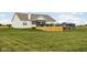 Large backyard featuring a wooden deck, a sunshade area, and a detached garage at 8225 W 825 N, Thorntown, IN 46071