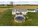 Aerial view of the back of the house showing a deck with an above ground pool and spacious yard at 8225 W 825 N, Thorntown, IN 46071