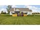 Well-manicured backyard features an elevated wooden deck with wood storage and a basketball court at 8225 W 825 N, Thorntown, IN 46071