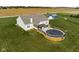 Aerial shot of the backyard showcasing the deck with above-ground pool and expansive grassy area at 8225 W 825 N, Thorntown, IN 46071