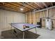 A basement with a ping pong table and exposed piping above at 8225 W 825 N, Thorntown, IN 46071