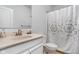 A well-lit bathroom with a vanity, mirror, and a shower with a decorative curtain at 8225 W 825 N, Thorntown, IN 46071