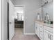Bright bathroom leads to bedroom with double sinks and white cabinets at 8225 W 825 N, Thorntown, IN 46071
