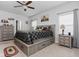 A cozy bedroom featuring a large bed with built-in storage drawers and rustic decor at 8225 W 825 N, Thorntown, IN 46071