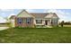Inviting single Gathering home with brick accents, blue shutters, and a manicured lawn at 8225 W 825 N, Thorntown, IN 46071
