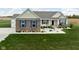 Well-maintained home featuring charming brickwork, blue shutters, and a lush green lawn at 8225 W 825 N, Thorntown, IN 46071