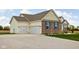 Attached two-car garage featuring white doors, brick accents, and manicured landscaping at 8225 W 825 N, Thorntown, IN 46071