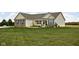 Attractive home with neat landscaping, pops of blue shutters, and an expansive front yard at 8225 W 825 N, Thorntown, IN 46071
