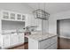 Contemporary kitchen with white cabinetry, granite counters, an island, and modern lighting fixtures at 8225 W 825 N, Thorntown, IN 46071