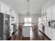 Open kitchen with a large island, stainless appliances, and adjacent dining area with outdoor access at 8225 W 825 N, Thorntown, IN 46071