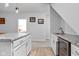 The kitchenette has light wood floors, white cabinets, and granite countertops with a beverage cooler at 8225 W 825 N, Thorntown, IN 46071