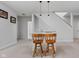 A wet bar featuring two wooden bar stools, granite counters, and stylish pendant lights at 8225 W 825 N, Thorntown, IN 46071